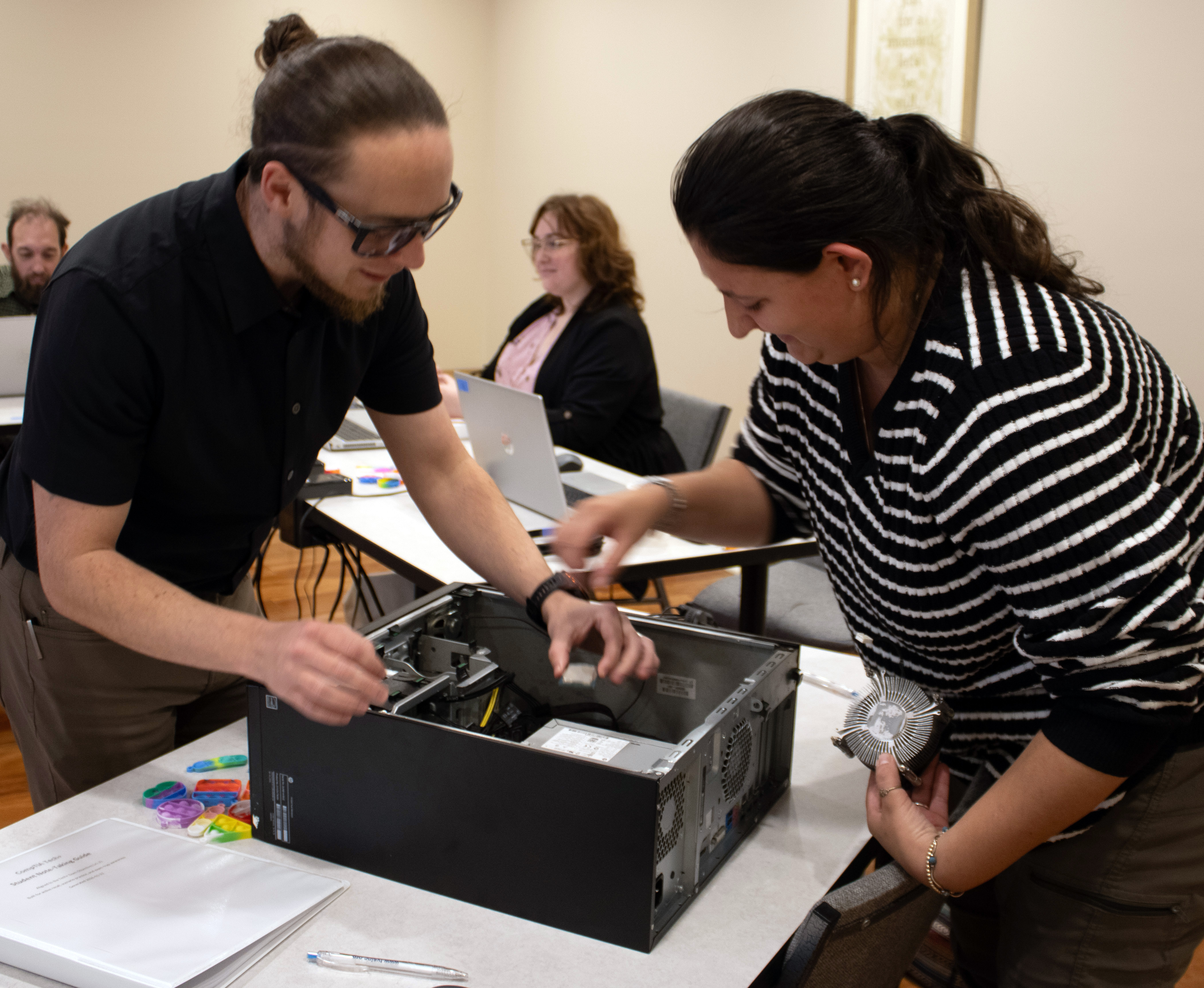 abilIT teacher and student work on computer. 
