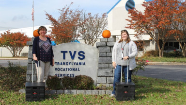 Jess & Montana standing outside TVS sign