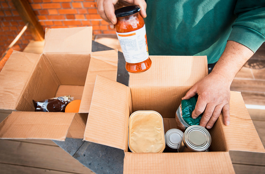 volunteer loading box with canned foods